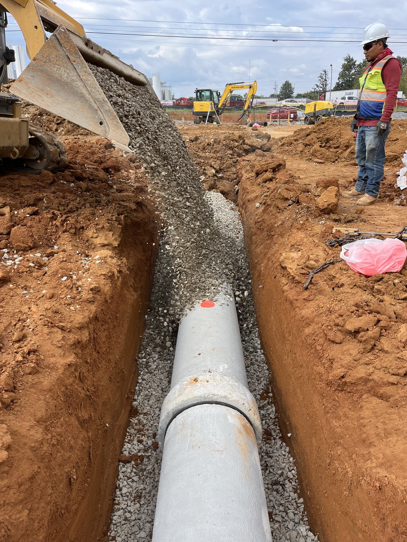 PMT Site crew backfilling over a newly installed water main